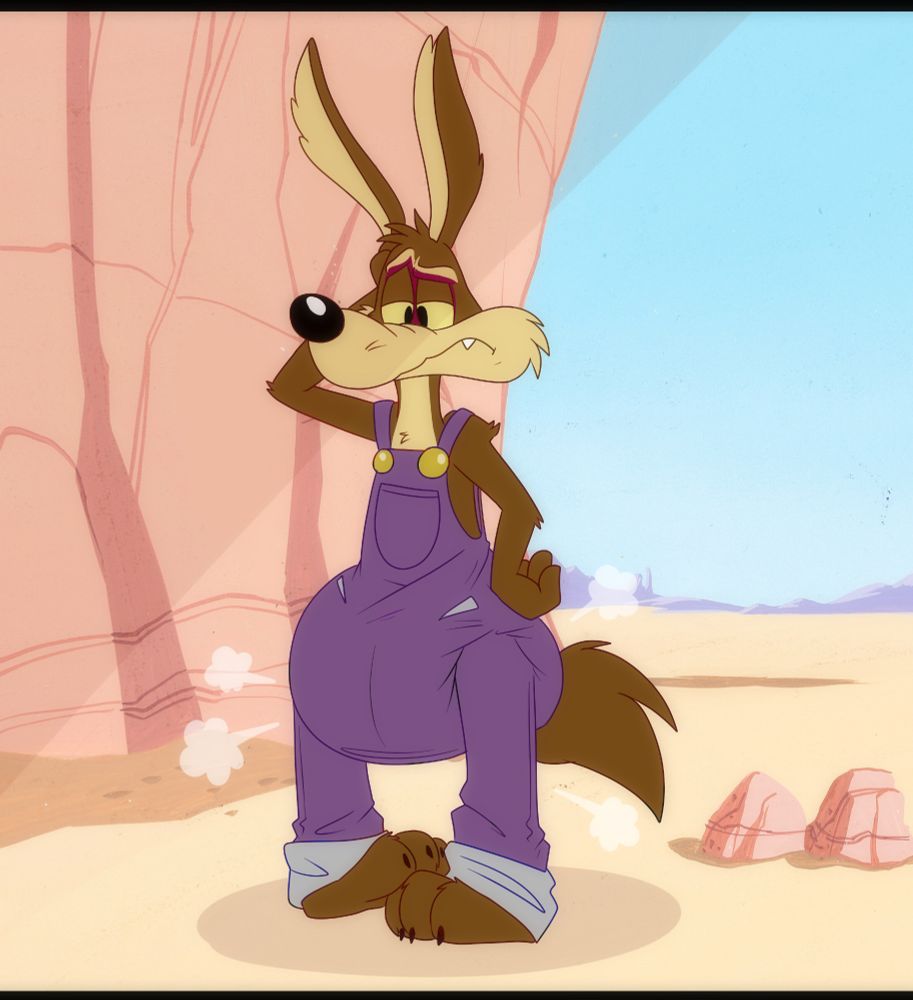 Wile E Coyote in his Bugs Bunny Builders overalls outfit with a poofy diaper stretching out his overalls