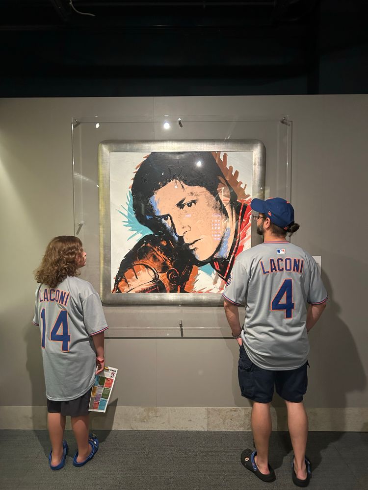 Two Mets fans in front of a Tom Seaver picture 