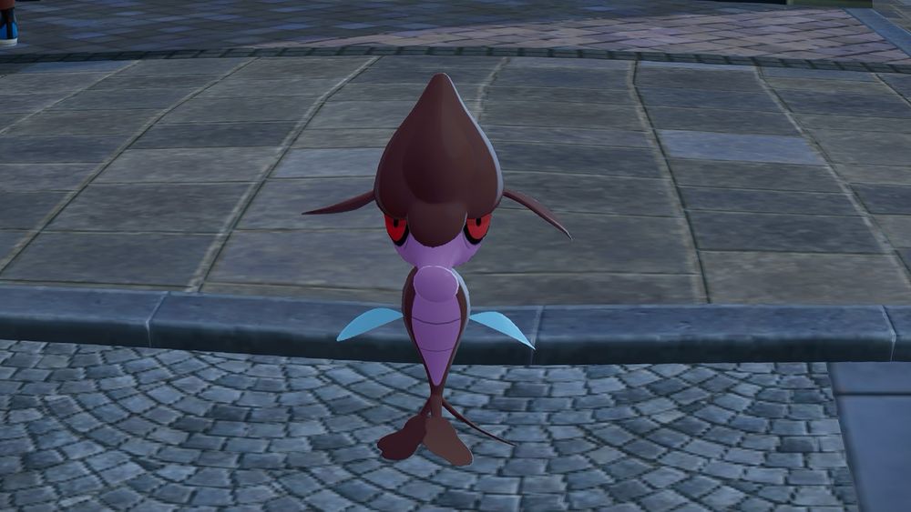 A screenshot of Pokemon Legends ZA. The pokemon Skrelp stares directly at the camera. A fish-eye lens effect is making it’s head look bigger than usual.