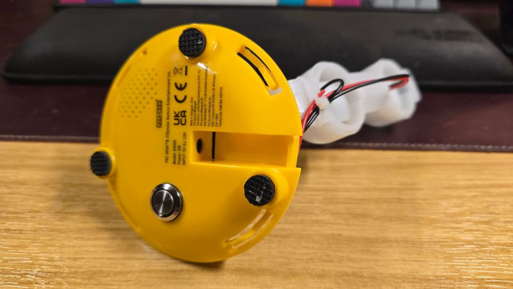 Yellow base of the lamp showing the latching push switch and power socket. The switch is about 1.5mm deep on the outside.