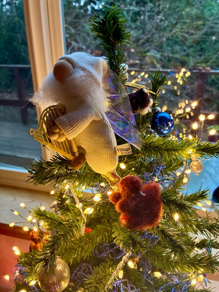 Tree topper: Little bearded angel in long Johns playing a harp. Felt squirrel next to him.