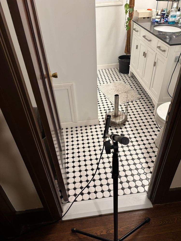 Waterphone on bathroom floor, boom mic stand outside the bathroom recording 