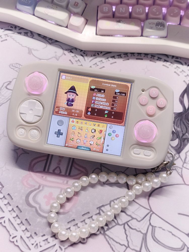 Pictured is a white anbernic rg cube with the game fantasy life on