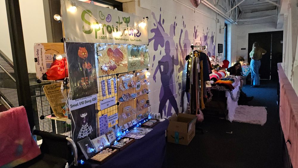 The alleyway leading to the Sproutdone booth.  The wall mural shows a purple splash mural.