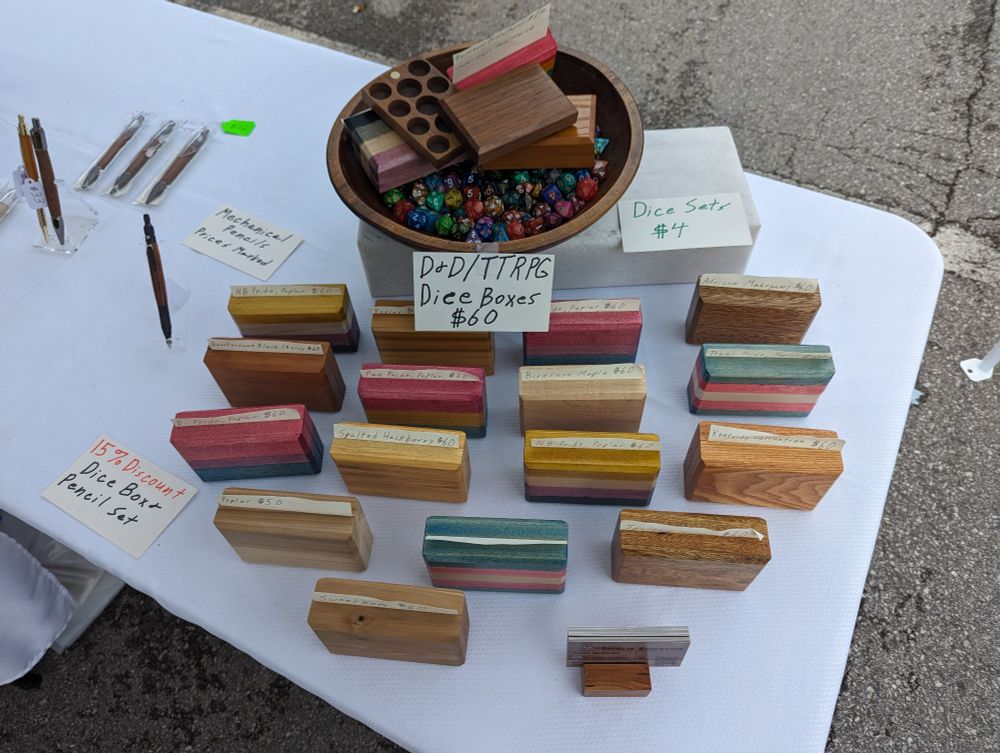 An assortment of wooden dice boxes on a white table.