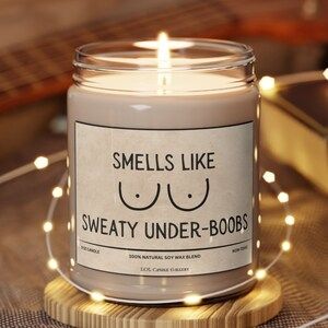 A little candle. The candle label reads SMELLS LIKE SWEATY UNDER-BOOBS

Image taken from an Etsy product that is no longer available 