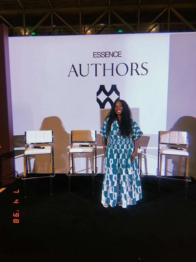 Black woman in boho braids in green and white dress on Essence Authors