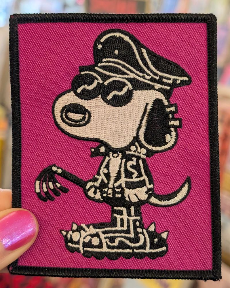 Embroidered patch with an illustration of Snoopy in the style of Tom of Finland