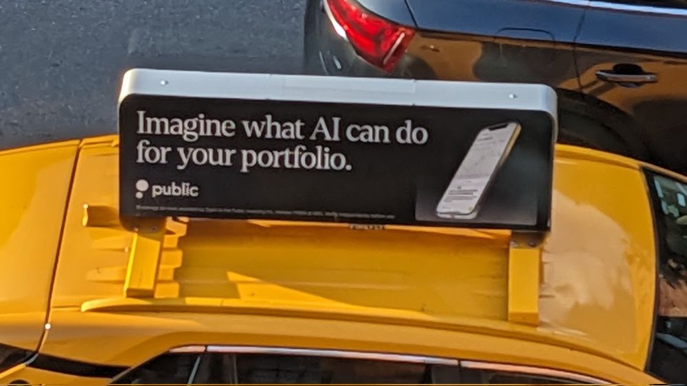 Rooftop ad on a NYC cab: "Imagine what AI can do for your portfolio"