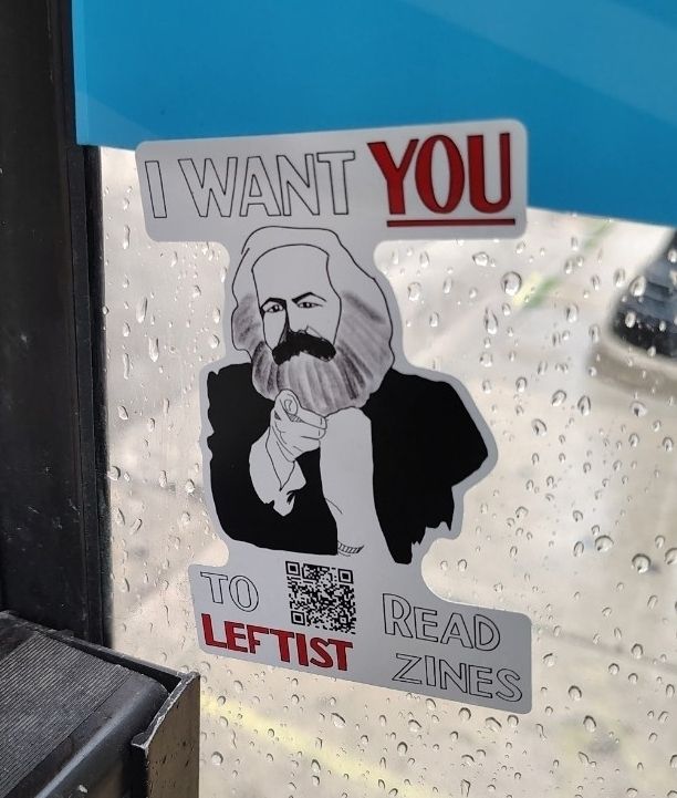A sticker depicting Marx pointing at the reader and the words "I want *you* to read *Leftist* zines"