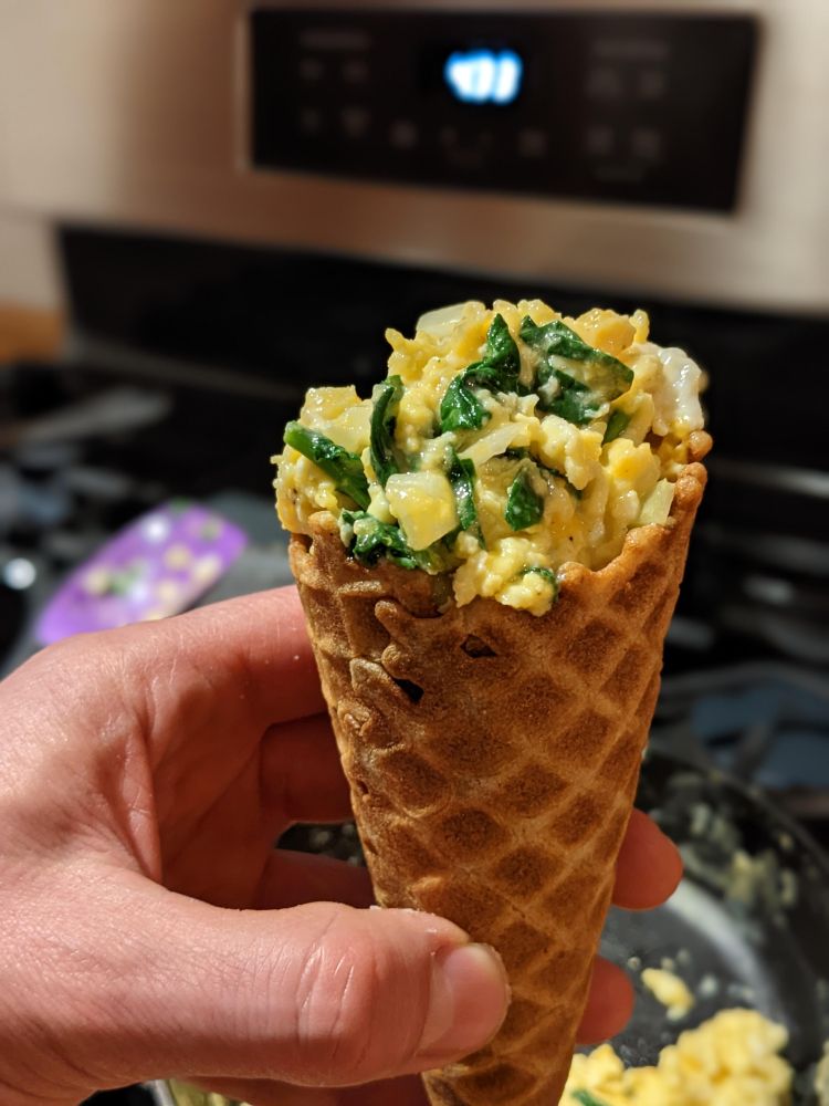 Scrambled eggs in a waffle cone. I call it "Walking Eggs"