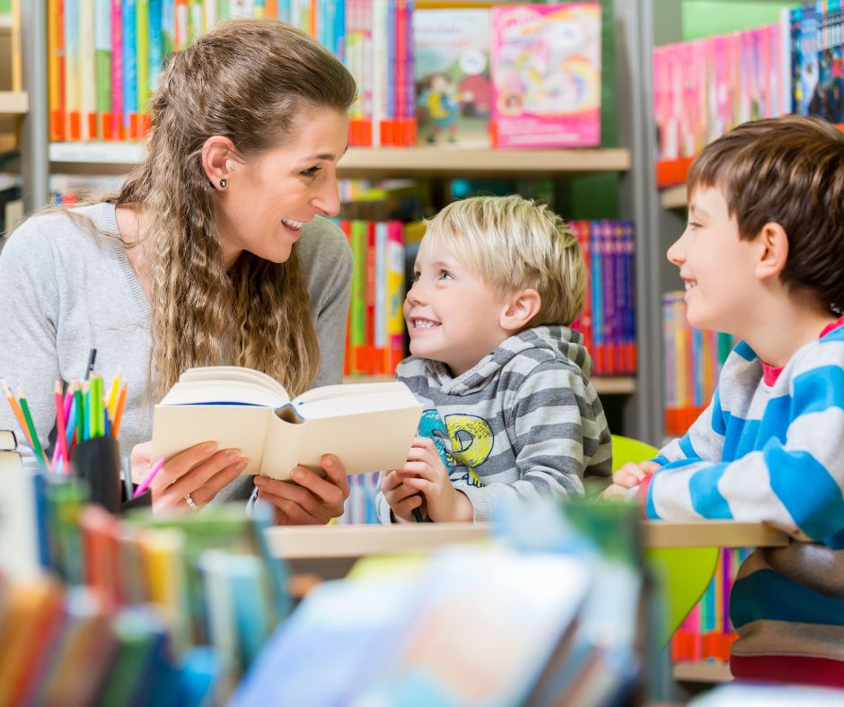 Image shows a family reading a book in a library 