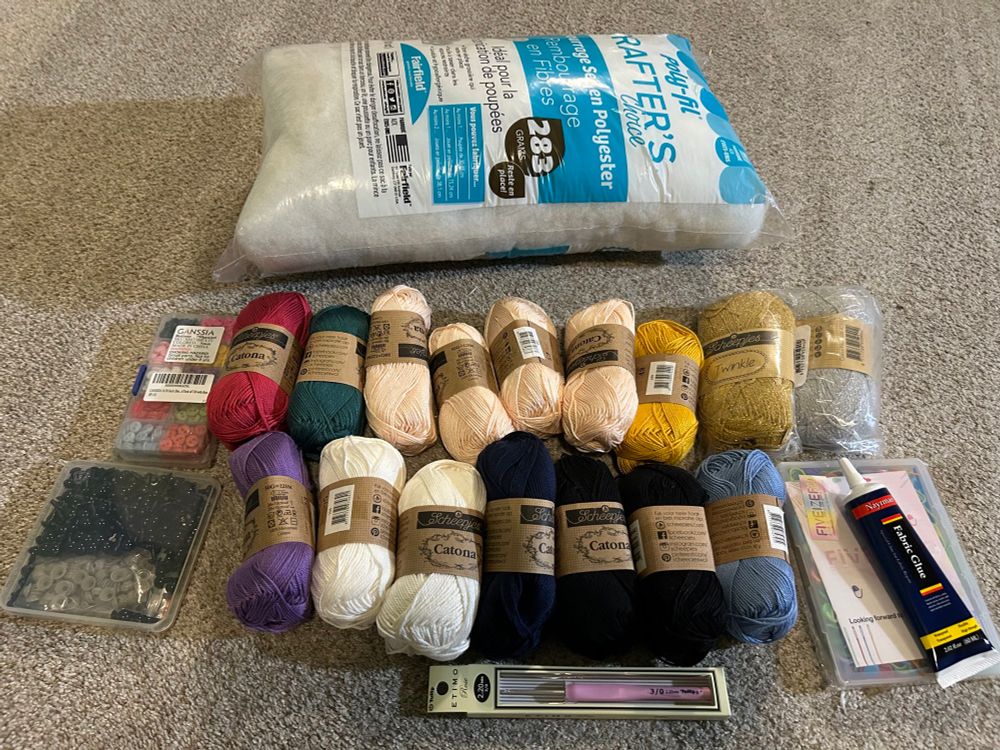 Materials to crochet Kpop demon hunter dolls - 15 types of yarn, boxes of buttons and doll eyes and a crochet hook also fabric glue 🧶