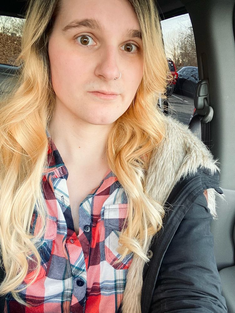 A Riley selfie with her freshly cut and styled hair, wearing a puffy faux-fur coat over a red flannel 