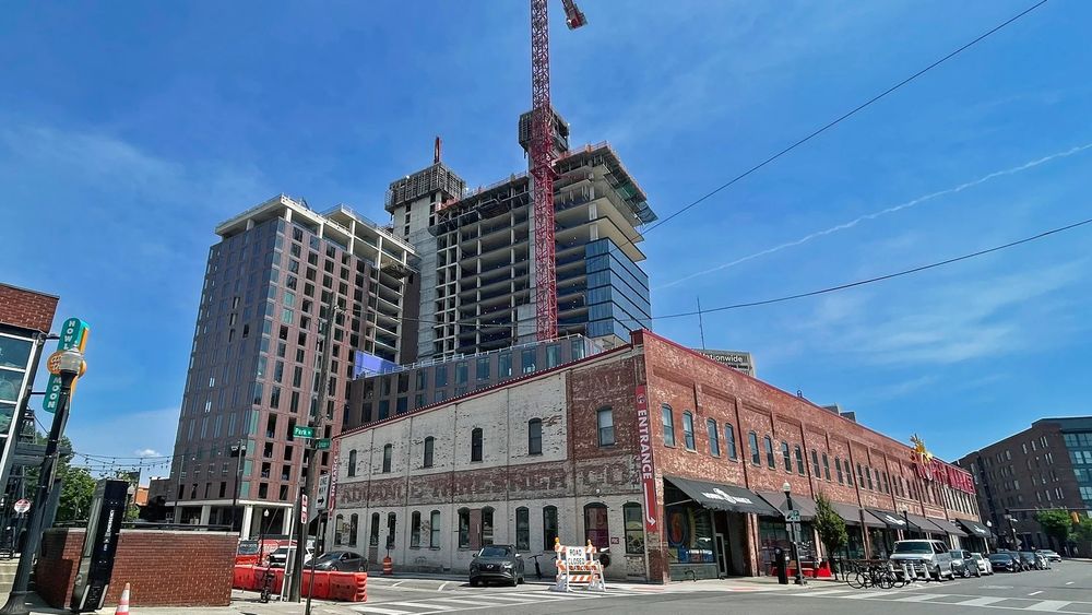 a tower is under construction behind the historic north market 