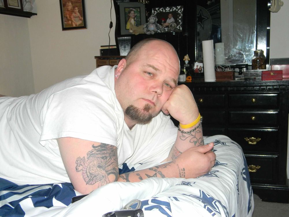 My late husband Billy laying on a bed.