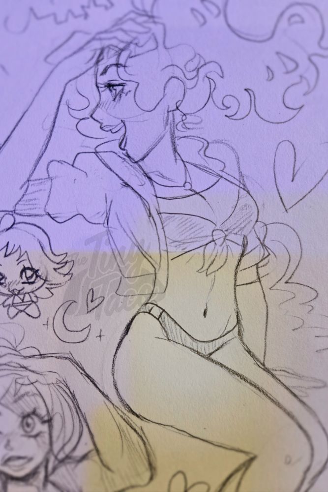 Daniella looking off to the left in her beach attire with her hair flowing 