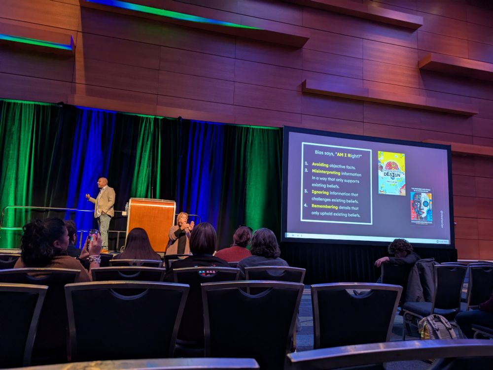 Dee Lanier on stage with a screen that displays text supporting ways to check bias.