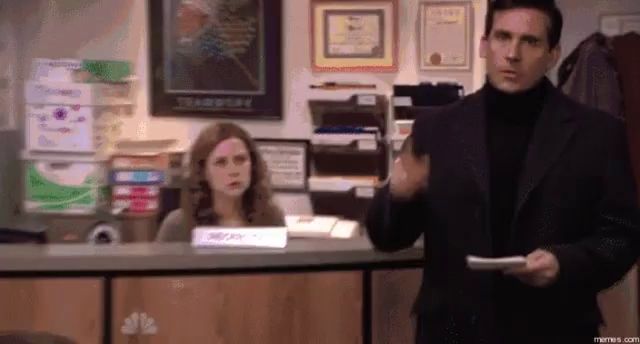 a man in a suit is holding a piece of paper in front of a woman behind a counter ..