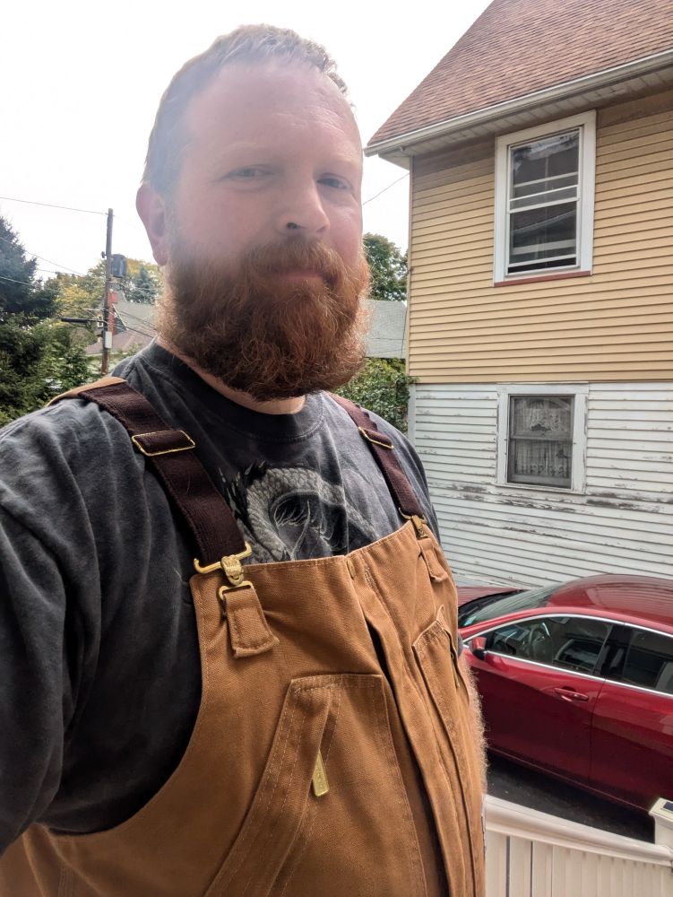 Me wearing brown overalls and Gray T-shirt 