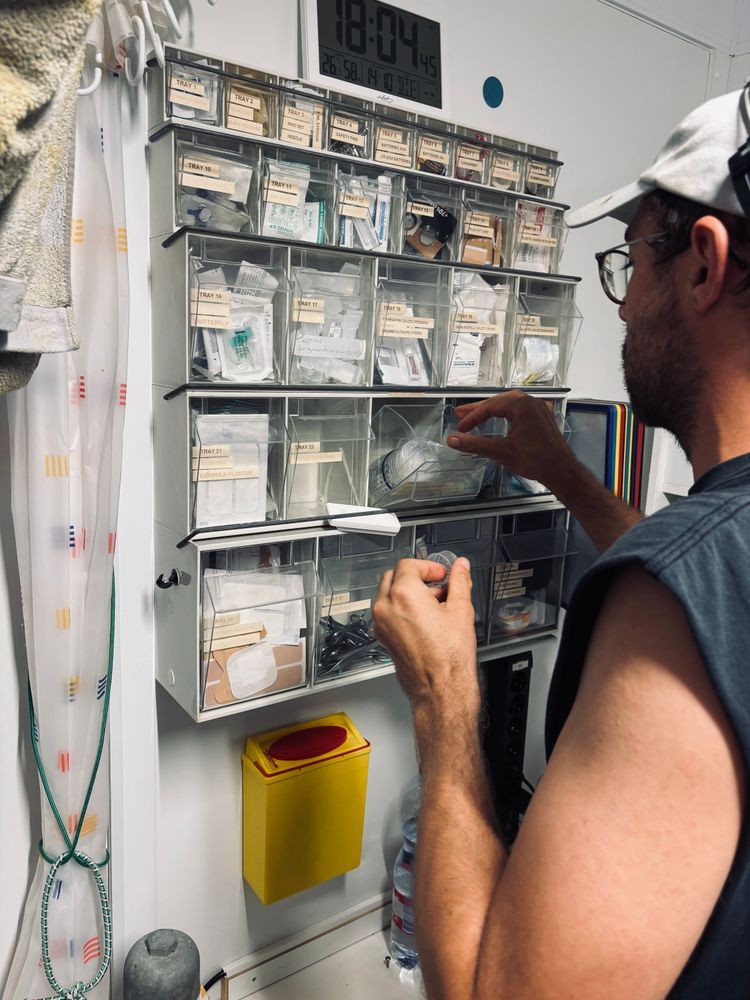 A medic checks and refills the ships pharmacy