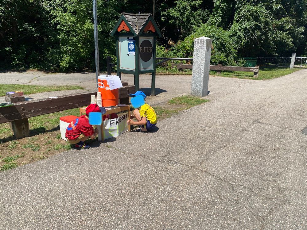 Kids setting up a lemonade stand along a trail