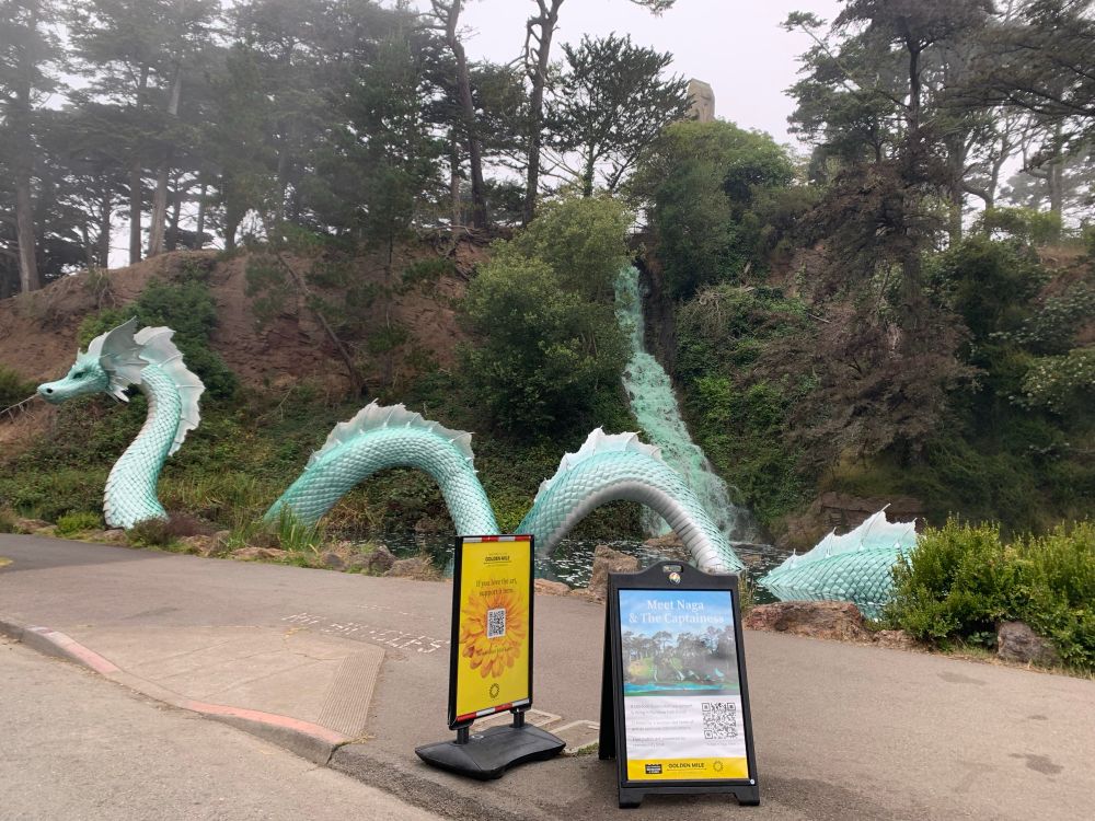 Sculpture of a green dragon called Naga next to a waterfall in Golden Gate Park, San Francisco