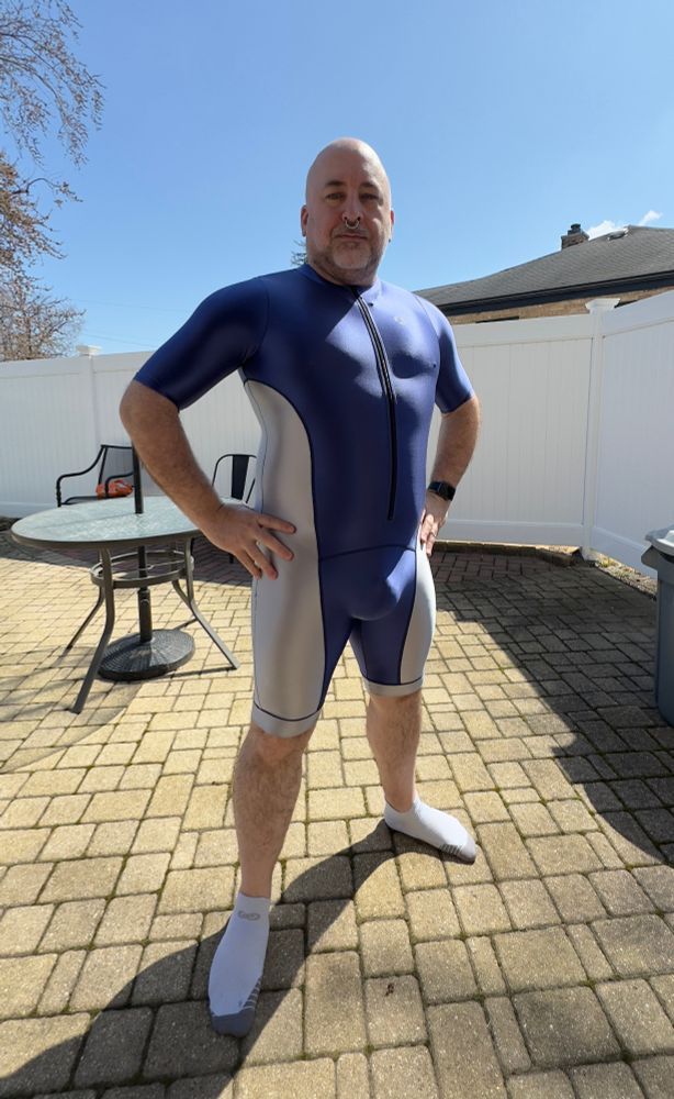 Blue and white one piece Amoresy spandex suit, short sleeves, short legs, worn by a bearish Reddy