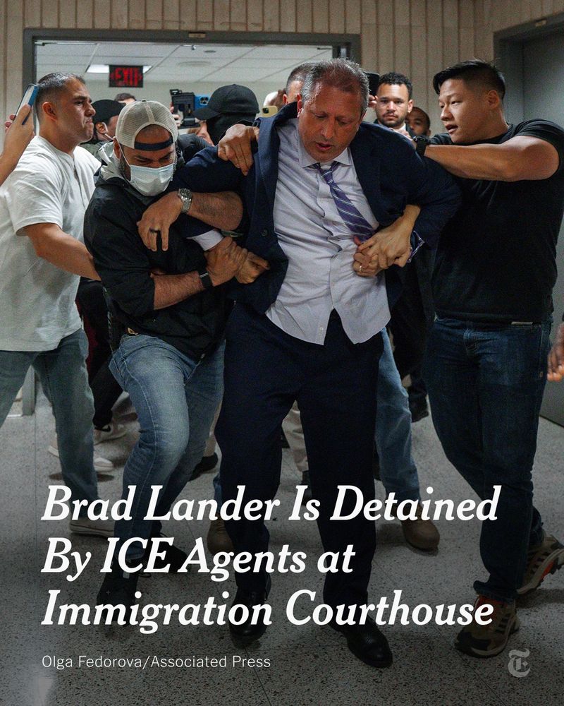 Brad Lander is shown being detained by federal agents in a courthouse. Lander wears a dark blue suit, blue shirt and blue striped tie. The agents wear sweatshirts and blue jeans. A headline reads: "Brad Lander Is Detained By ICE Agents at Immigration Courthouse." Photo by Olga Fedorova/Associated Press.