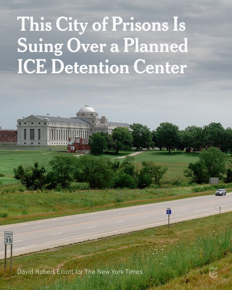 A domed building sits on a lot with trees and greenery beside a roadway with a car. A headline reads: "This City of Prisons Is Suing Over a Planned ICE Detention Center" Photo by David Robery Elliott for The New York Times