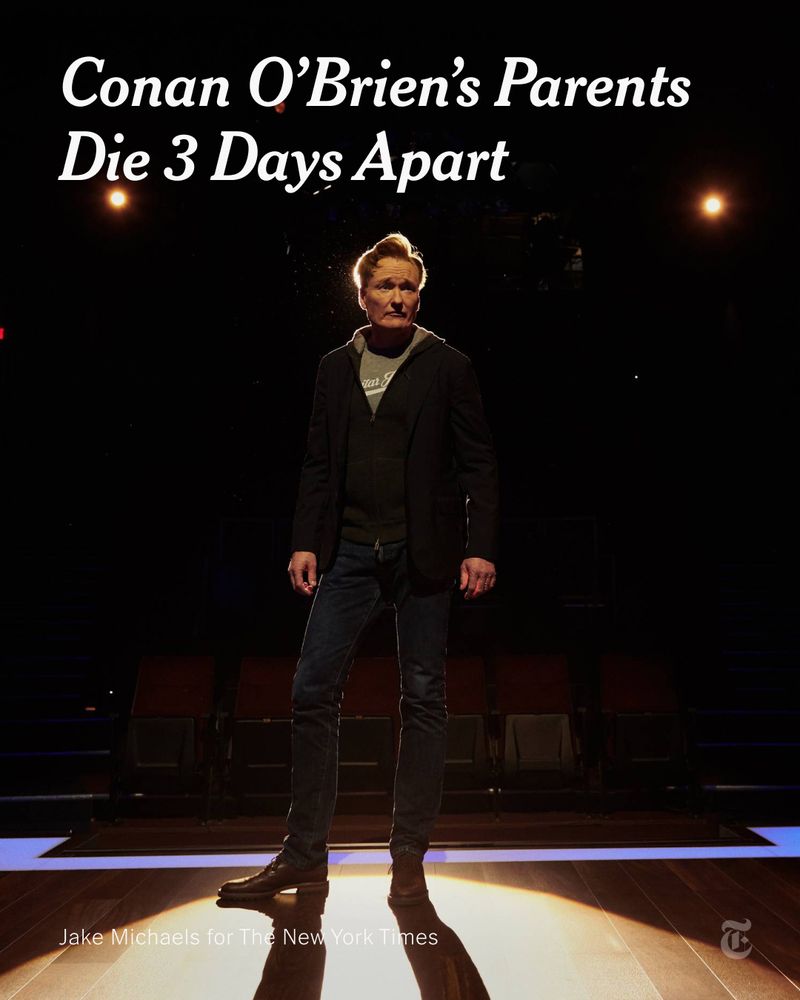 Conan O'Brien is pictured standing on a wooden stage in a dark auditorium, backlit by stage lights. Headline reads: "Conan O’Brien’s Parents Die 3 Days Apart." Photo credit: Jake Michaels for The New York Times. 