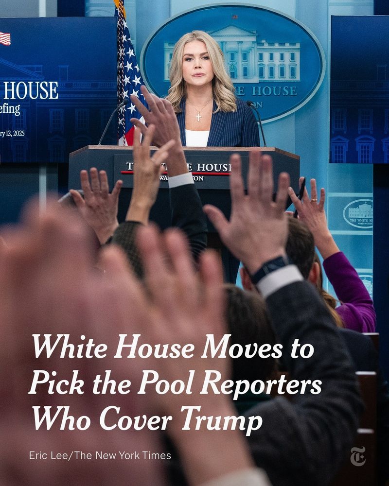 White House Press Secretary Karoline Leavitt, wearing a navy blue pinstriped blazer, a white shirt and a cross necklace, speaks during a press briefing at the White House as reporters raise their hands. Text reads: "White House Moves to Pick the Pool Reporters Who Cover Trump." Eric Lee/The New York Times