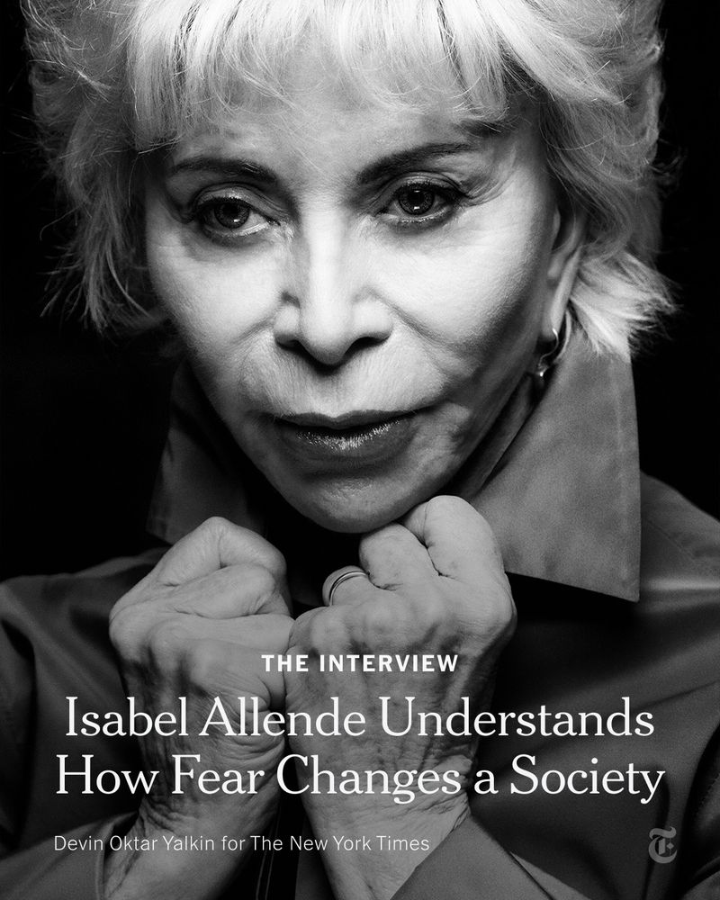 Isabel Allende poses while flipping up the collar of her shirt. A headline reads: "The Interview: Isabel Allende Understands How Fear Changes a Society." Photo by Devin Oktar Yalkin for The New York Times.