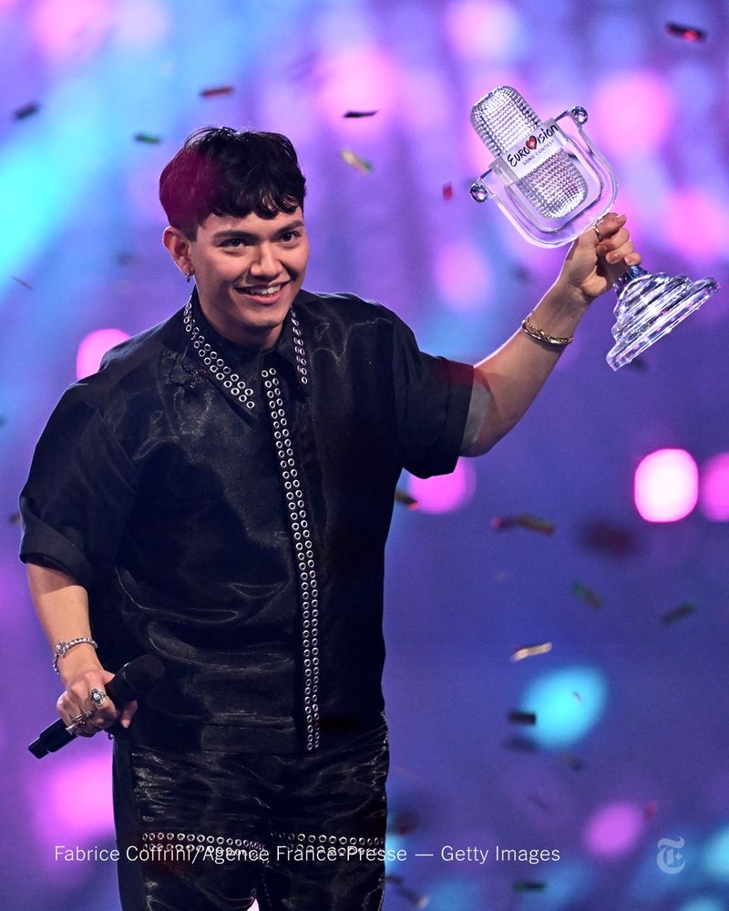 Austria’s entrant, JJ, is holding up a Eurovision trophy as confetti rains down. Photo by Fabrice Coffrini/Agence France-Presse — Getty Images
