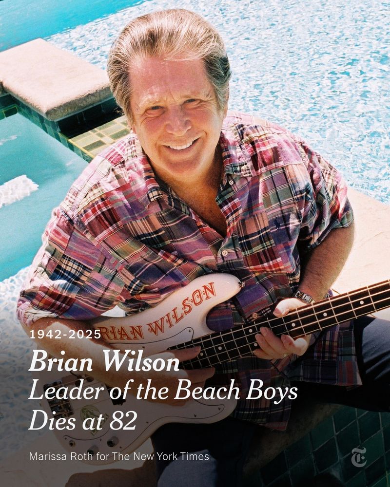 Brian Wilson wears a plaid shirt and holds a guitar with his name on it. A headline reads: "Brian Wilson, Leader of the Beach Boys, Dies at 82." Photo credit: Marissa Roth for The New York Times.