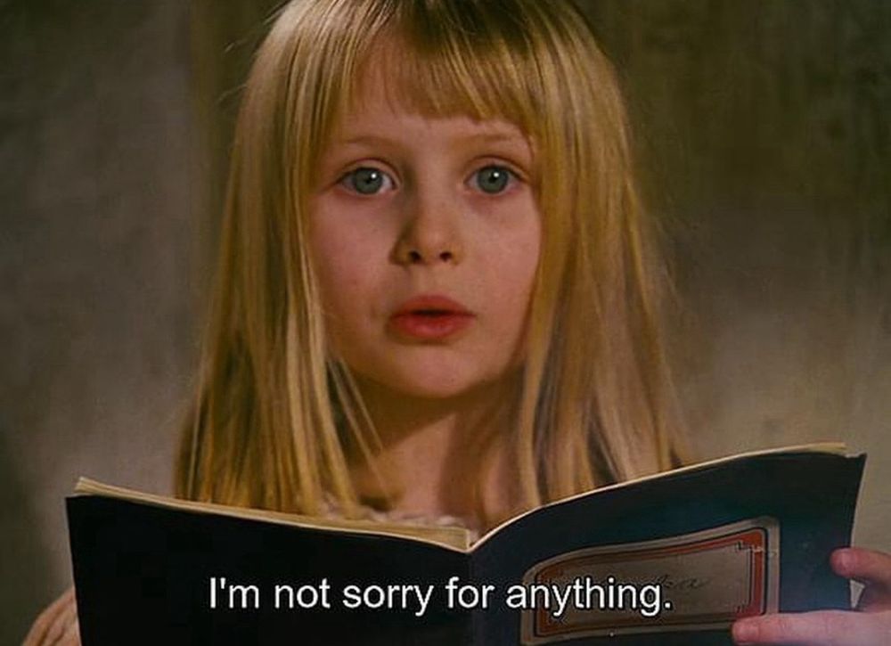 a white blonde girl holding a book with captions that read “i’m not sorry for anything”