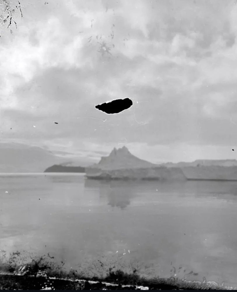  In 2013, researchers discovered 22 unprocessed photographic negatives frozen in a block of ice at Cape Evans, Antarctica.
The images were taken by the Ross Sea Party, a lesser-known group from Ernest Shackleton's 1915-1917 expedition.
Their ship, Aurora, had drifted away, leaving them stranded in brutal conditions-three men died before rescue.
The negatives were carefully thawed and developed, revealing rare, never-before-seen glimpses of early Antarctic exploration.
A powerful find that revives a forgotten chapter in polar history.

A black and white photograph in antarctica, glaciers in the distance like a mountain. A small hole in the film is above the glacier, leaving a black eerie space. 
