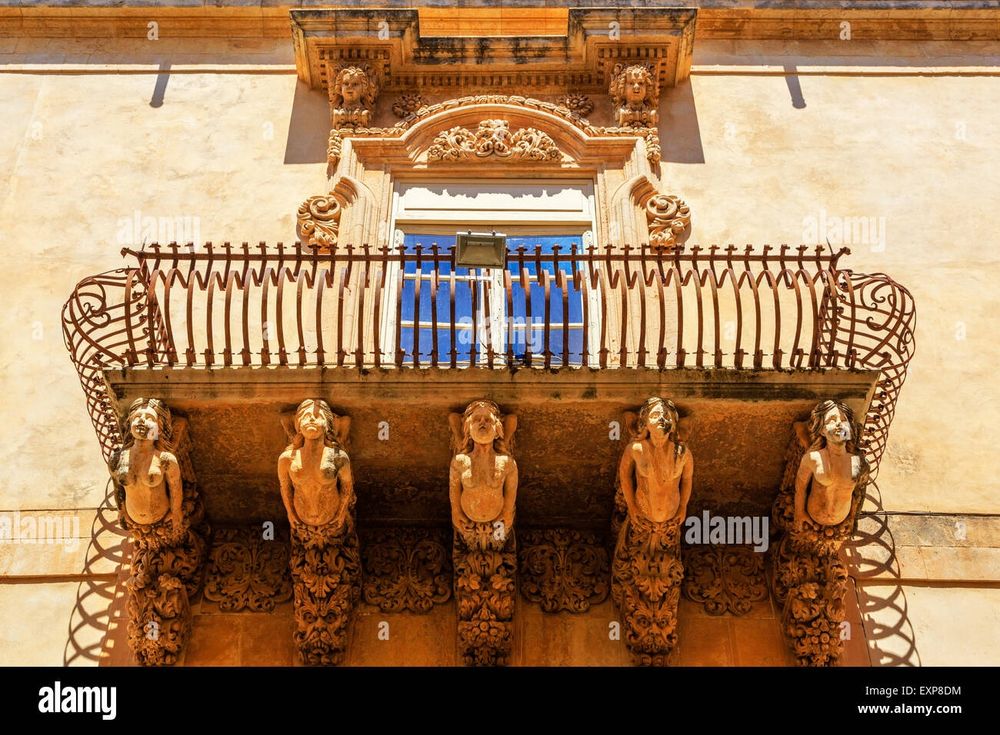 Baroque balcony with statuette buttresses