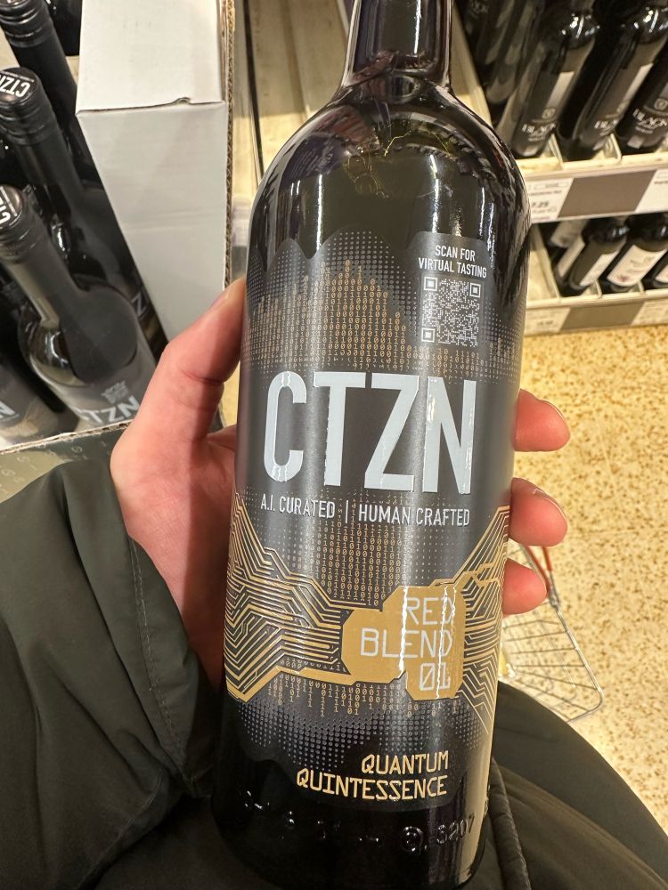 Photo of a wine bottle that says “ai curated, human crafted” 
