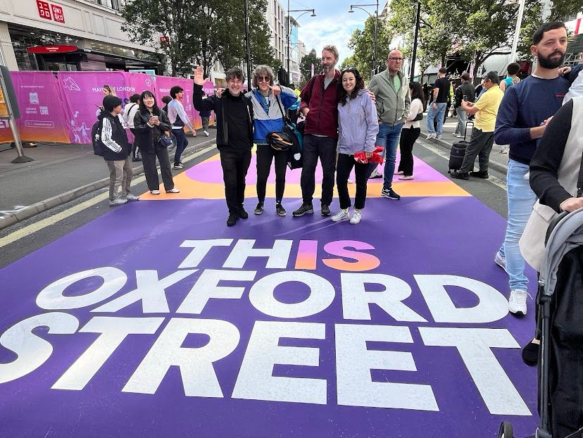 5 people standing in middle of Oxford Street on car-free day  