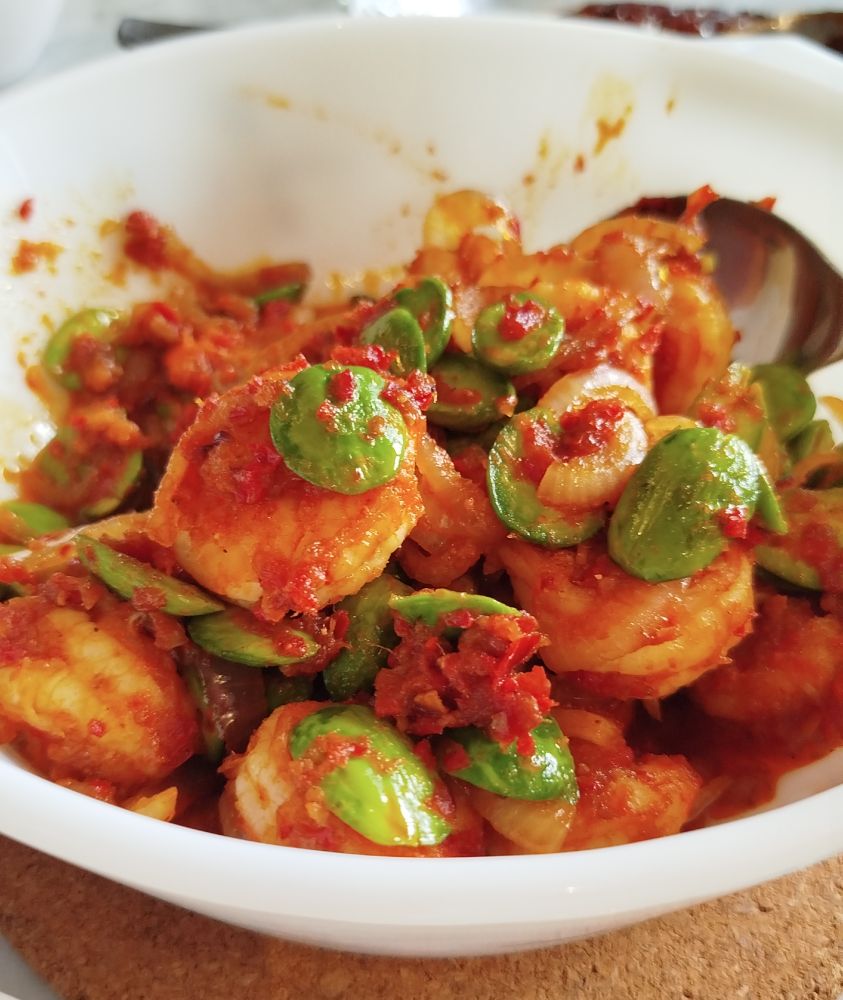 A bowl of prawns and petai beans fried in sambal (chilli paste). 