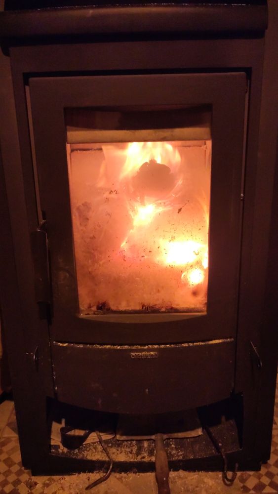 A wood stove with a (fucking) fire with maybe my ring into it...