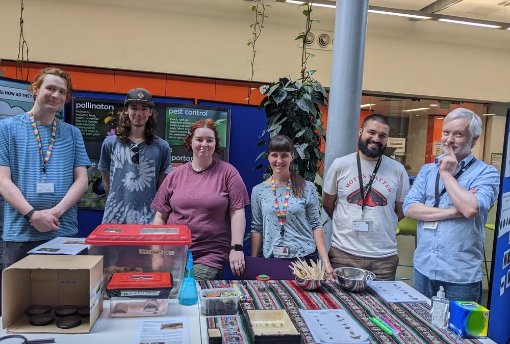 Researchers at an insect outreach event, standing at the stall