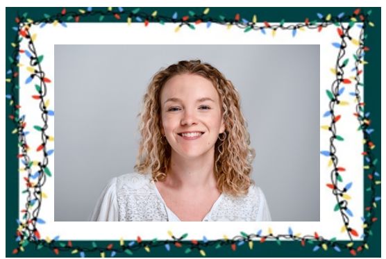 photo of a smiling woman in a white top against a great background. The woman has blond curly hair and is wearing earrings. The photo is surrounded by a festive themed border.