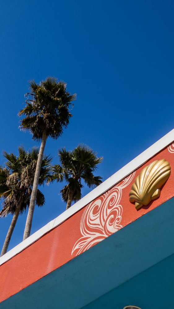 Three palm trees above the roofline of the Looff carousel. In 1911, one of the greatest carousel carvers of all time, Charles I.D. Looff, delivered a shimmering new carousel to the Boardwalk.