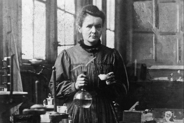 Marie Curie in a posed photo in her lab. She