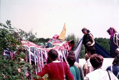 A snapshot of women building a paper mache dragon.