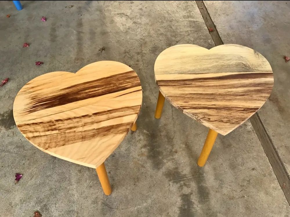 two wooden, heart-shaped mini stools