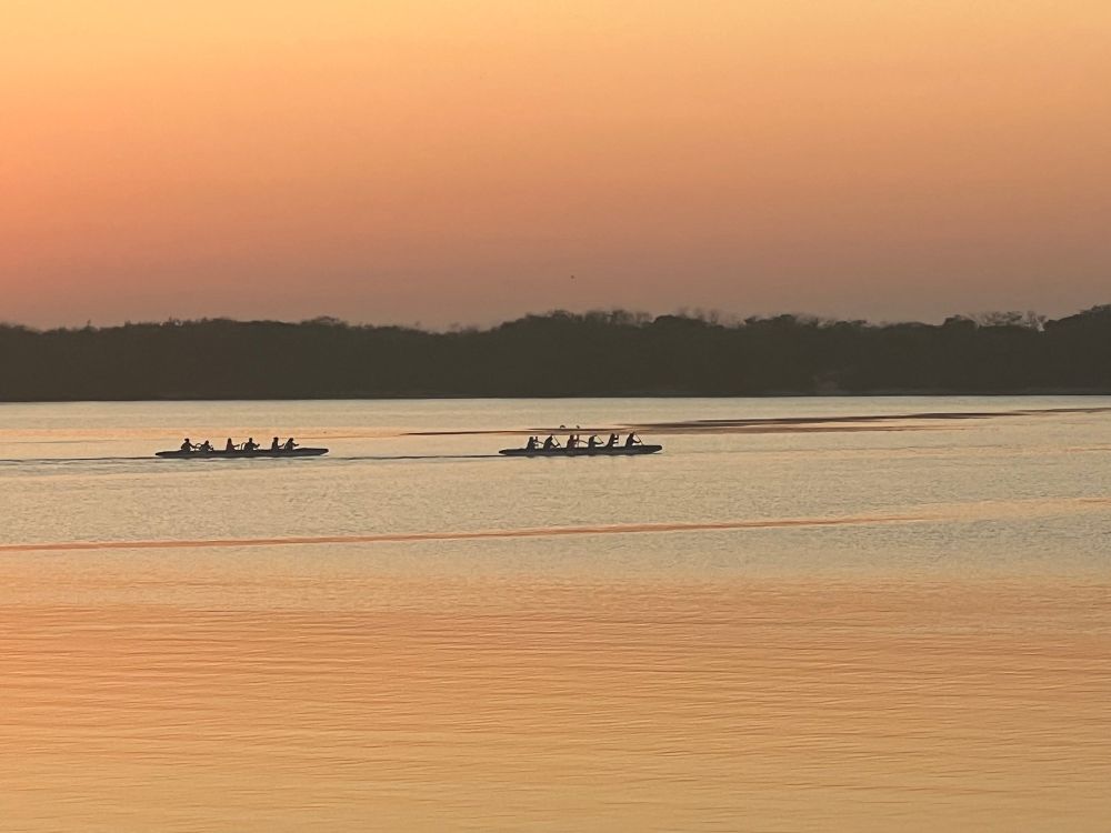 Two outriggers on Pumicestone Passage at sunrise.
