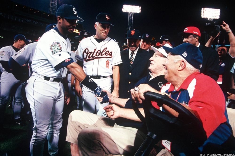 Ken Griffey Jr., left, shakes hands with Ted Williams as Cal Ripken Jr. looks on before the start of the 1999 MLB All-Star Game. (Rich Pilling/MLB Photos)